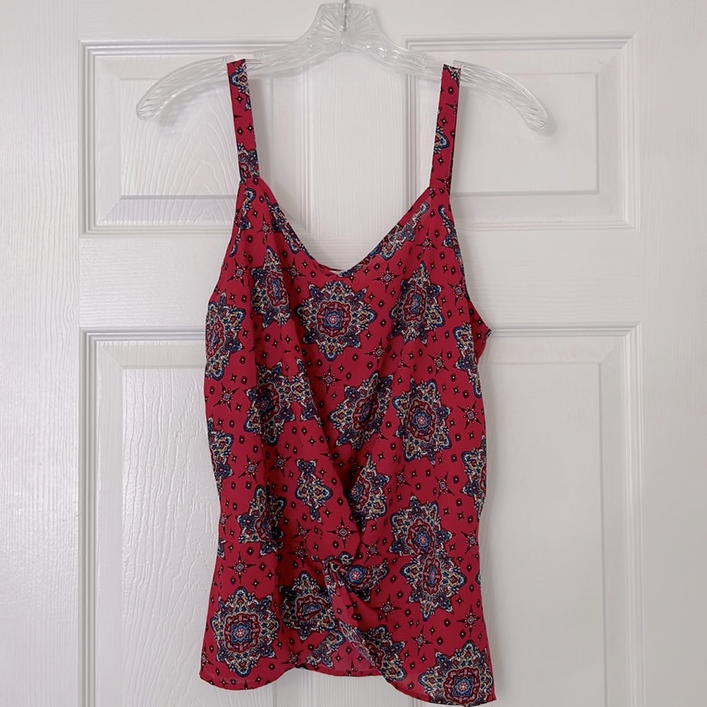 Pattern tank with a knot tie in front.